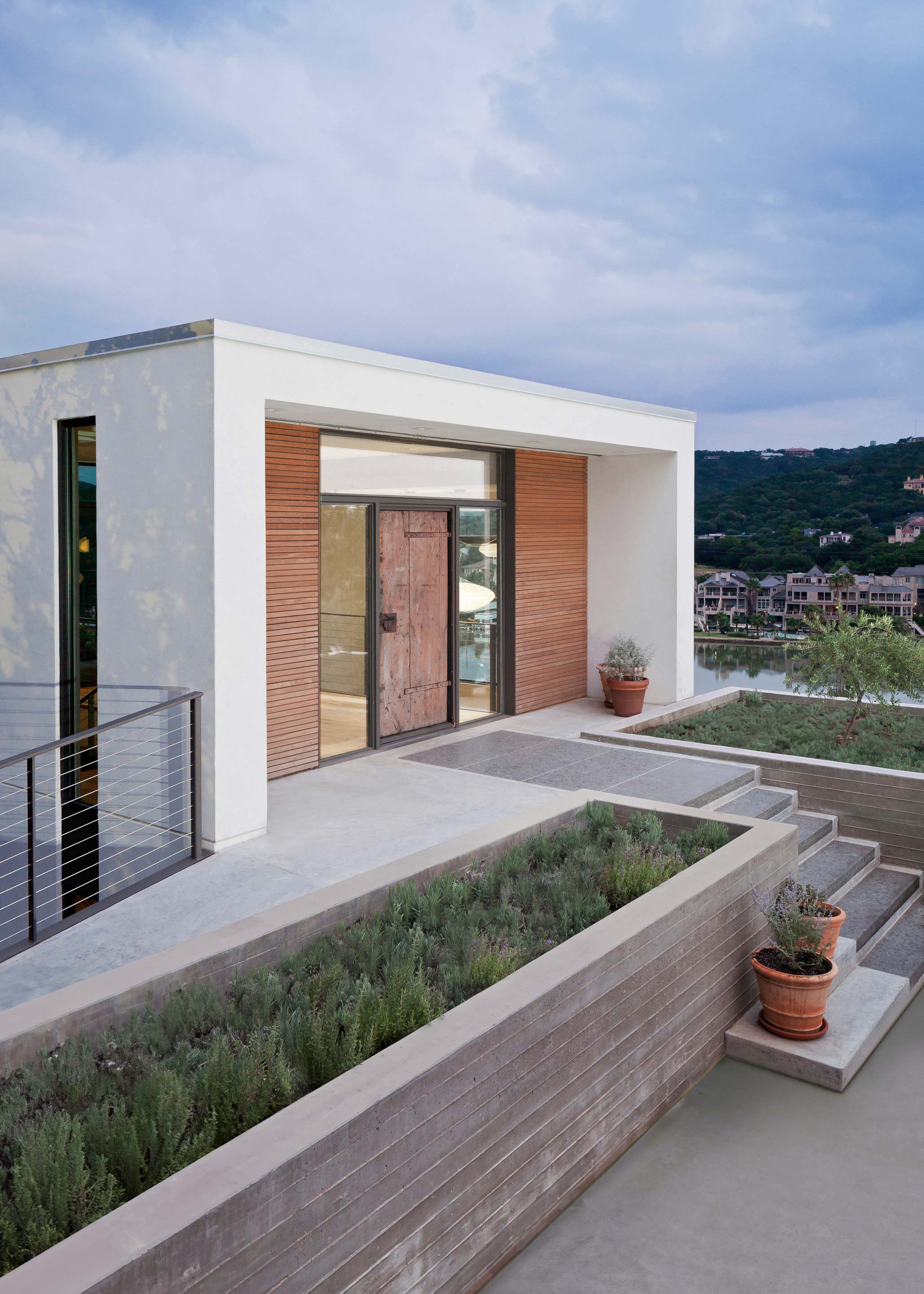Exterior photo of the Cliffside Residence by Specht Novak Architects. Shot by Andrea Calo, featuring the welcoming and unassuming entryway of the home.